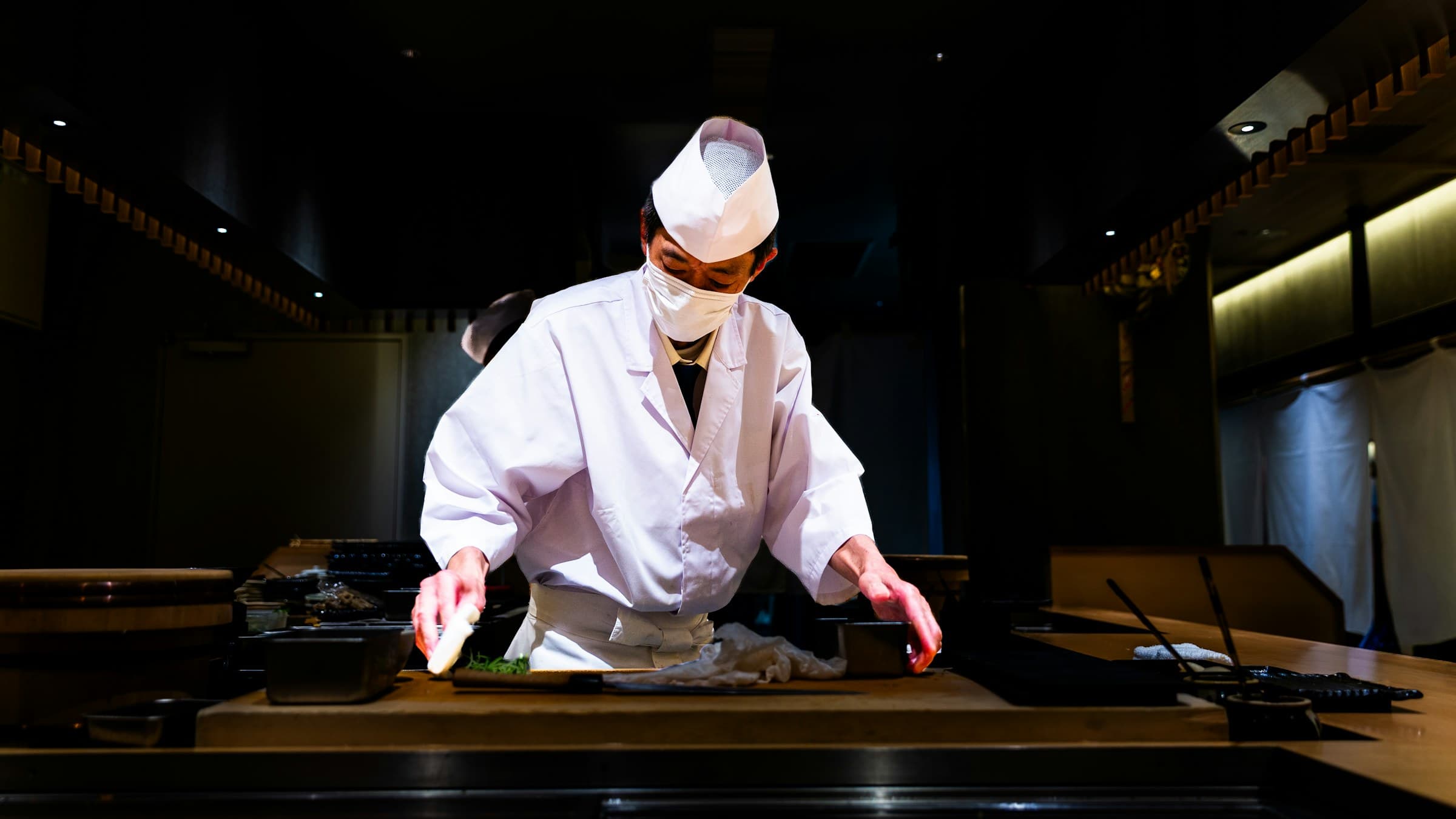 Sushi chef working behind a counter in Tokyo